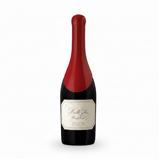A bottle of Pérle Glais Rose Noël from Les Artisans, featuring a dark glass body, a cream-colored label, and a vibrant red foil capsule covering the neck and upper shoulder.