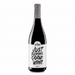 A bottle of Neleman Organic Red Wine with a bold white label reading 'JUST FUCKING GOOD WINE' in black lettering, topped with a black and white striped foil, set against a solid peach background.