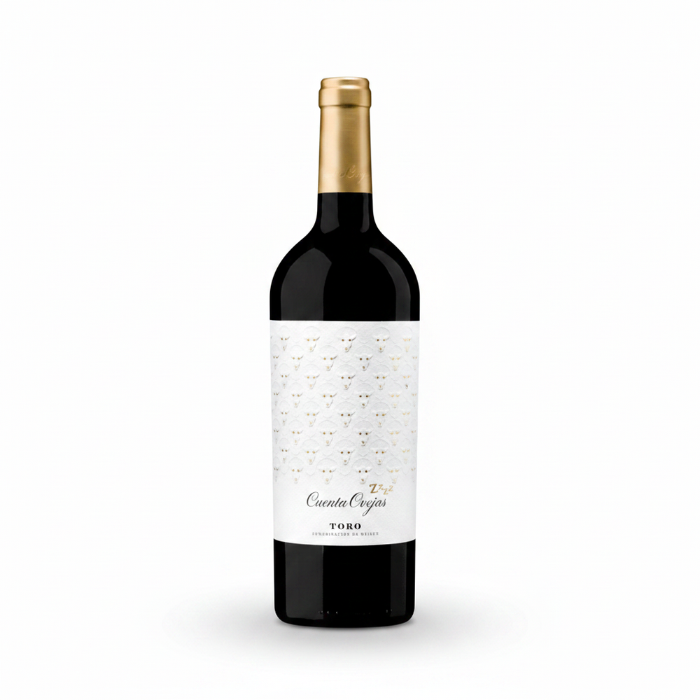 A bottle of Counta Orgas Toro red wine, featuring a white label with a delicate gold trellis pattern and a gold foil-wrapped neck, set against a solid dark teal background.